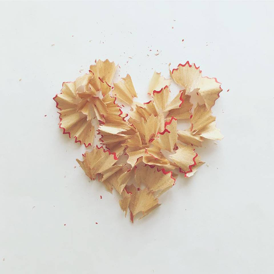 Photo of heart made from pencil shavings on white paper